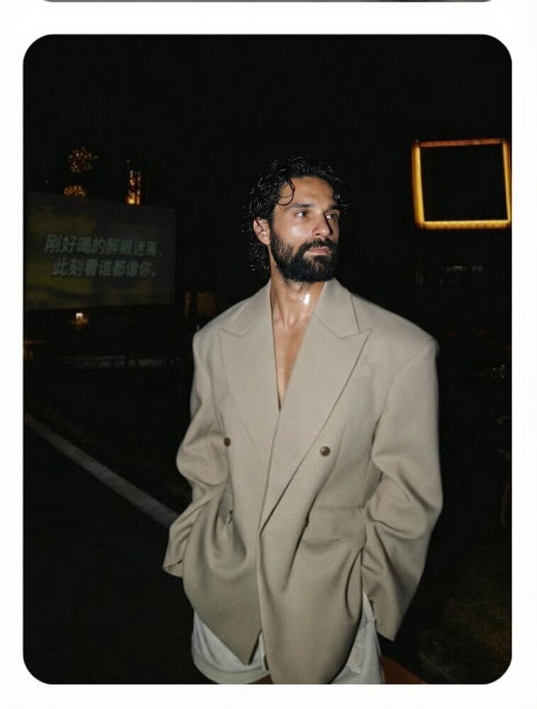 Amos Le Blanc, Canadian film director, standing in an oversized beige suit