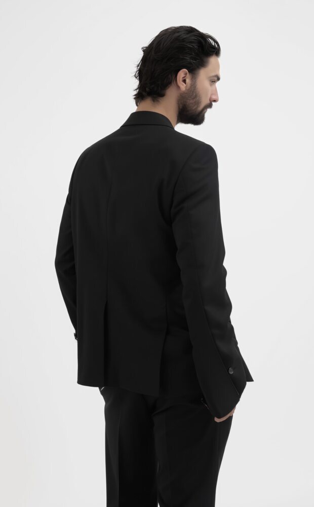 Amos Le Blanc, Canadian film director, studio headshot in a tailored suit